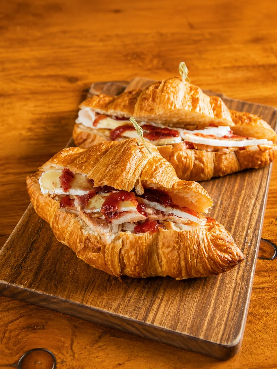 Filled croissants on a wooden board
